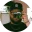A self-portrait photograph of the author holding an SLR camera viewfinder to his eye, obsuring this face.
