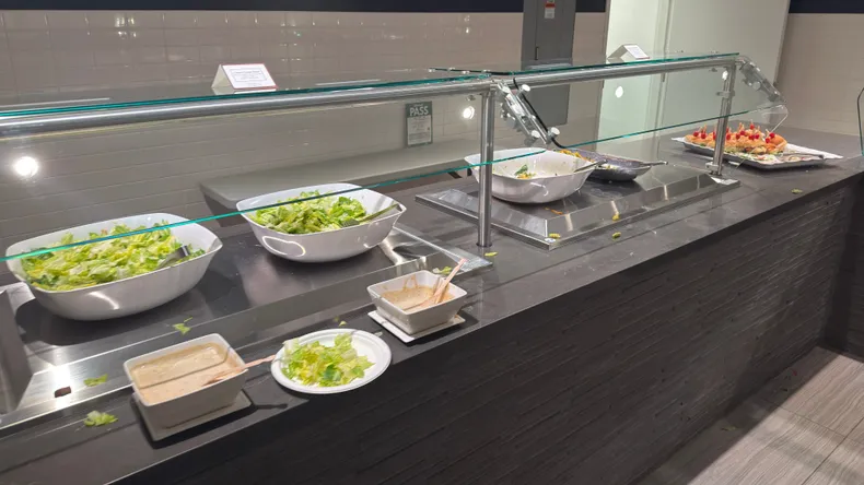 A depressing photo of a buffet station with barely any food left.