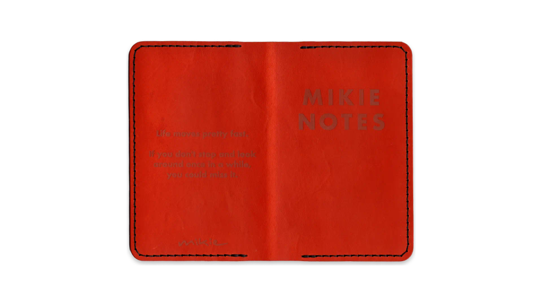 A scanned image of a one-of-a-kind pocket notebook leather folio, in orange with black thread.