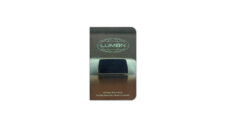 A digital scan of the cover of the journal I used during April, 2025. It is a custom MIKIE NOTES ‘Lumon Industries’ edition, featuring an image of a conference speaker on a desk, from a episode of Severance, Season 1.